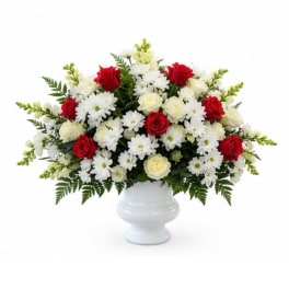 Red roses and white daisies in a white vase