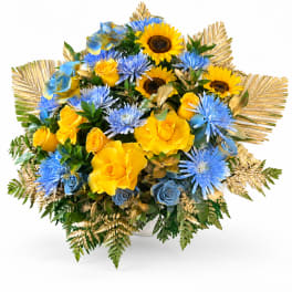 Bouquet of yellow roses and blue flowers in a white vase