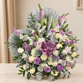 Large purple and white floral arrangement with silver fan-like leaves