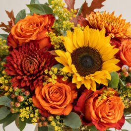 Bouquet of orange roses, sunflowers, and red chrysanthemums