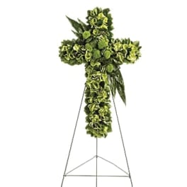 Green floral cross on a metal stand
