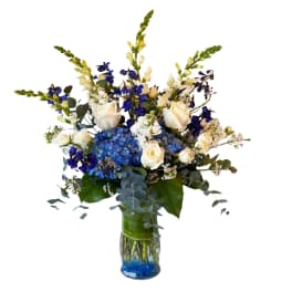 Blue and white floral arrangement in a glass vase
