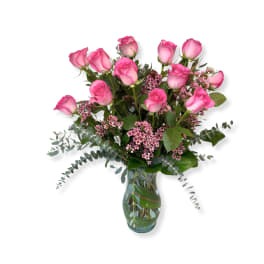 Pink roses and small pink flowers in a glass vase