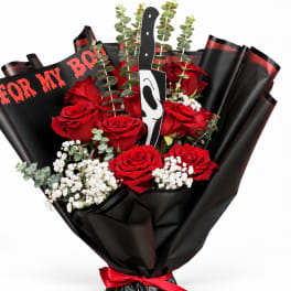 Bouquet of red roses with black wrapping and a horror mask topper