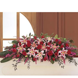 Long floral arrangement with red roses and pink lilies