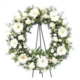 White floral funeral wreath on a stand