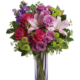 Pink and purple mixed bouquet in a tall purple vase