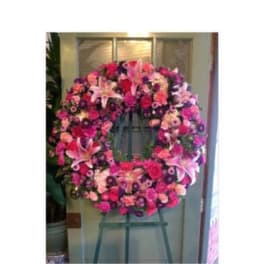 Large pink and purple floral wreath on an easel