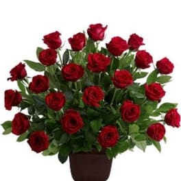 Arrangement of red roses in a brown urn vase