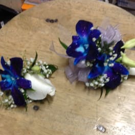 Blue and white floral corsages with ribbon accents