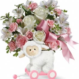 Pink and white rose bouquet with a plush lamb on wheels