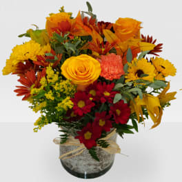 Bouquet of yellow and red flowers in a glass vase
