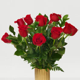 Red roses arranged in a gold vase