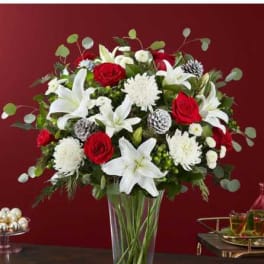 Red roses and white lilies in a clear glass vase