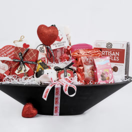 Heart-themed gift basket with chocolates and red decorations