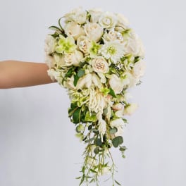 Trailing bouquet of white and pale green flowers with cascading greenery