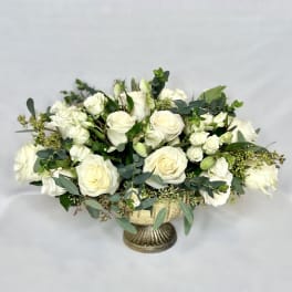 White rose bouquet in a gold pedestal vase