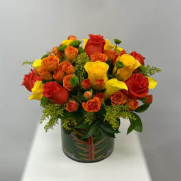 Bouquet of red, orange, and yellow roses in a decorative vase