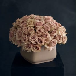 Bouquet of pale pink roses in a beige vase