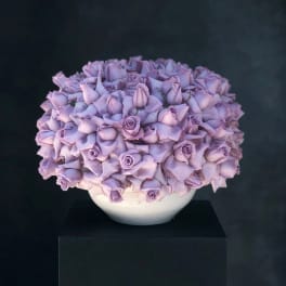 Lavender rose arrangement in a white bowl vase