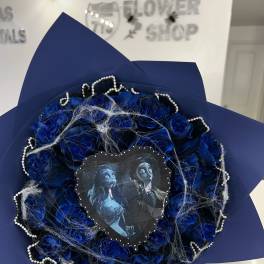Blue rose bouquet with a decorative heart topper and pearl trim