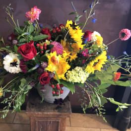 Colorful mixed flower arrangement in a gray vase
