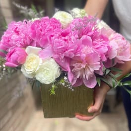 Pink and white bouquet in a square vase