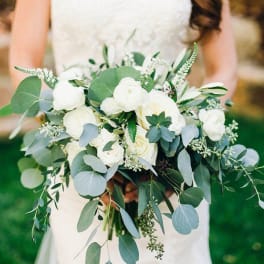Bride holding a white bouquet with eucalyptus greenery