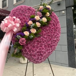 Heart-shaped floral standing arrangement with pink and lavender roses