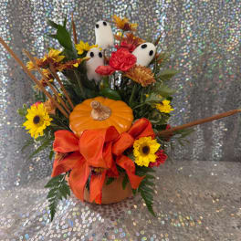 Halloween floral arrangement with a pumpkin, ghost picks, and orange ribbon