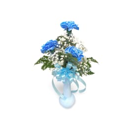 Blue carnations and white baby's breath in a light blue vase with ribbon