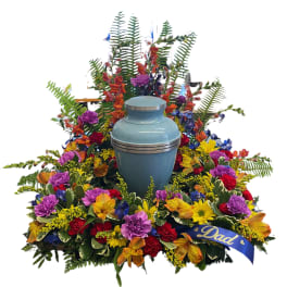 Colorful funeral spray with a blue urn and a Dad ribbon