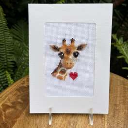 Cross-stitch greeting card with a giraffe and red heart