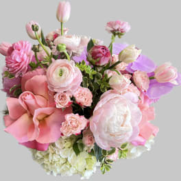 Pink and white bouquet with tulips, roses, and ranunculus