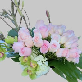 Bouquet of pale pink roses with green orchids and white hydrangea