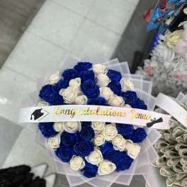 Bouquet of blue and white roses with a graduation ribbon