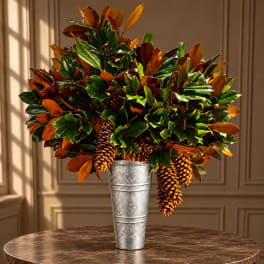 Autumn foliage arrangement in a tall metal vase