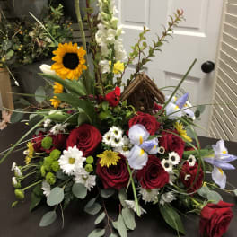 Mixed bouquet with red roses, sunflowers, and white flowers