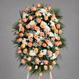 Peach roses and white flowers arranged on a standing easel spray