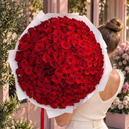 Large bouquet of red roses wrapped in white paper