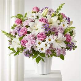 Pink roses and white lilies in a white vase