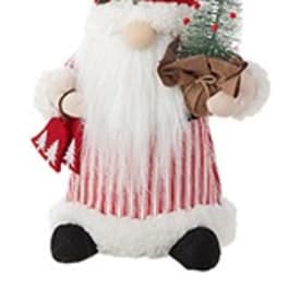 Santa figurine with a red hat, white beard, and small Christmas tree