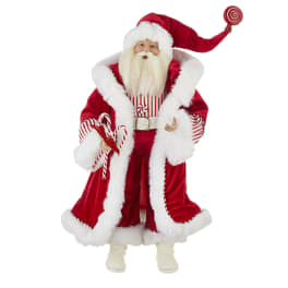 Santa figurine in a red velvet coat holding candy canes