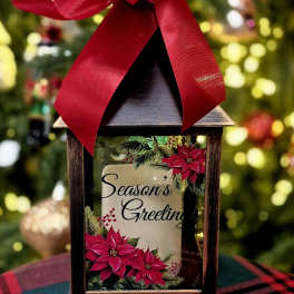 Decorative lantern with a red bow and a "Season's Greetings" holiday insert