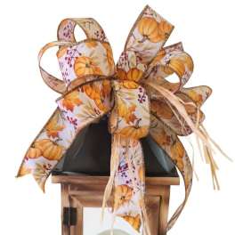 Decorative wooden lantern with a pumpkin-print ribbon bow and candle inside