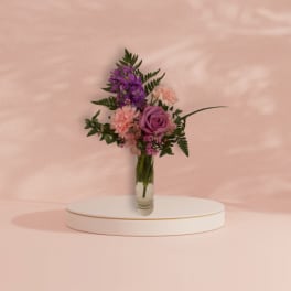 Pink and purple bouquet in a clear glass vase