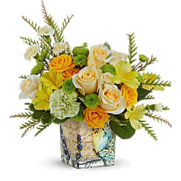 Yellow and white roses in a painted glass vase