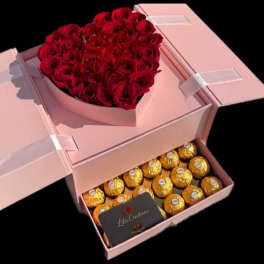 Heart-shaped box of red roses with chocolates in a pink gift box