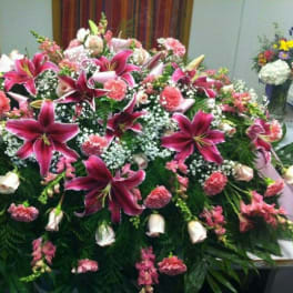 Large casket spray with pink lilies and carnations