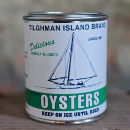 Can of oysters with a sailboat label on a table